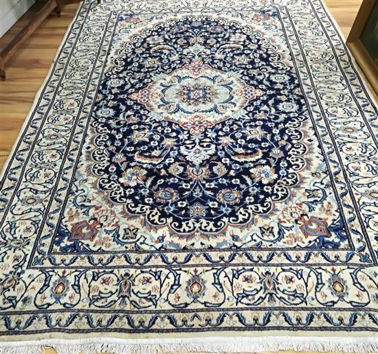 A Nain silk inlaid carpet, 295cm x 200cm.